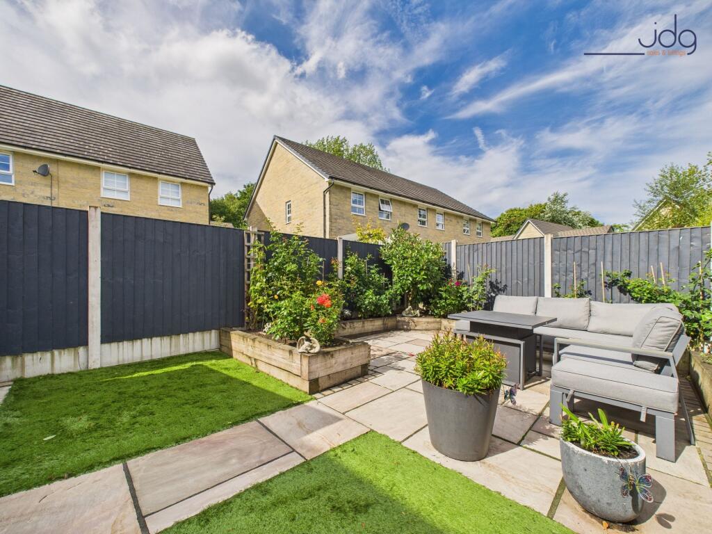 Beautifully Landscaped Garden with mixture of flags and artificial grass