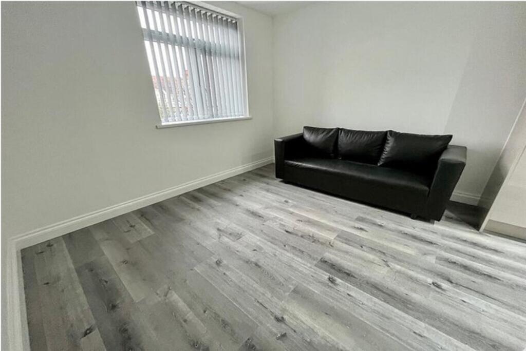 Bright and modern living room featuring a comfo...