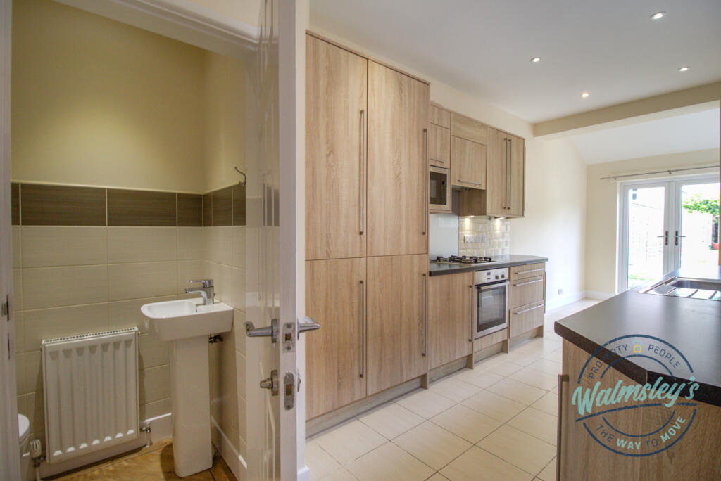 Kitchen with cloalroom off rear reception