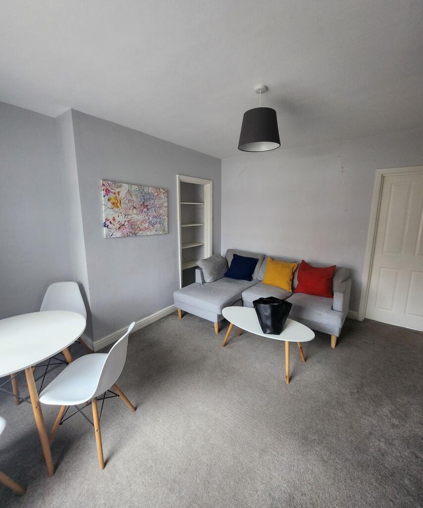 Welcoming and brightly lit living room featurin...