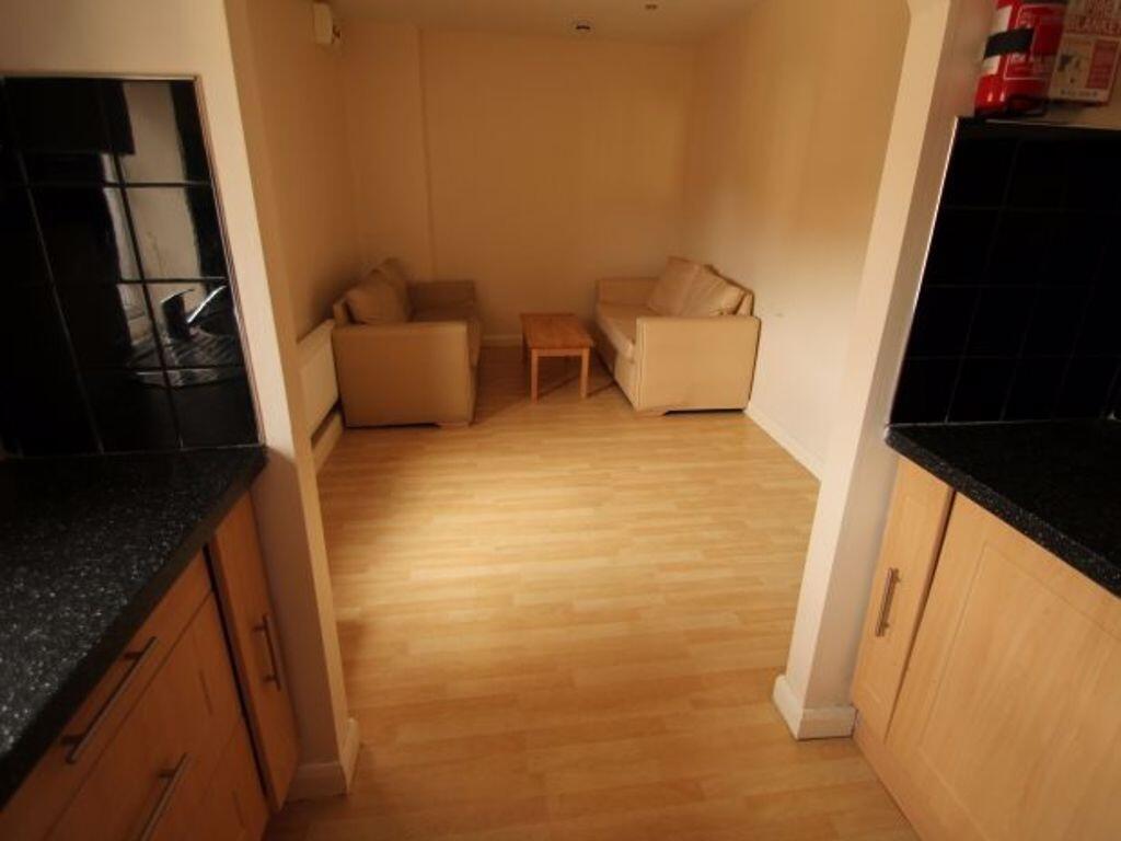 A cozy living room with light wooden flooring a...