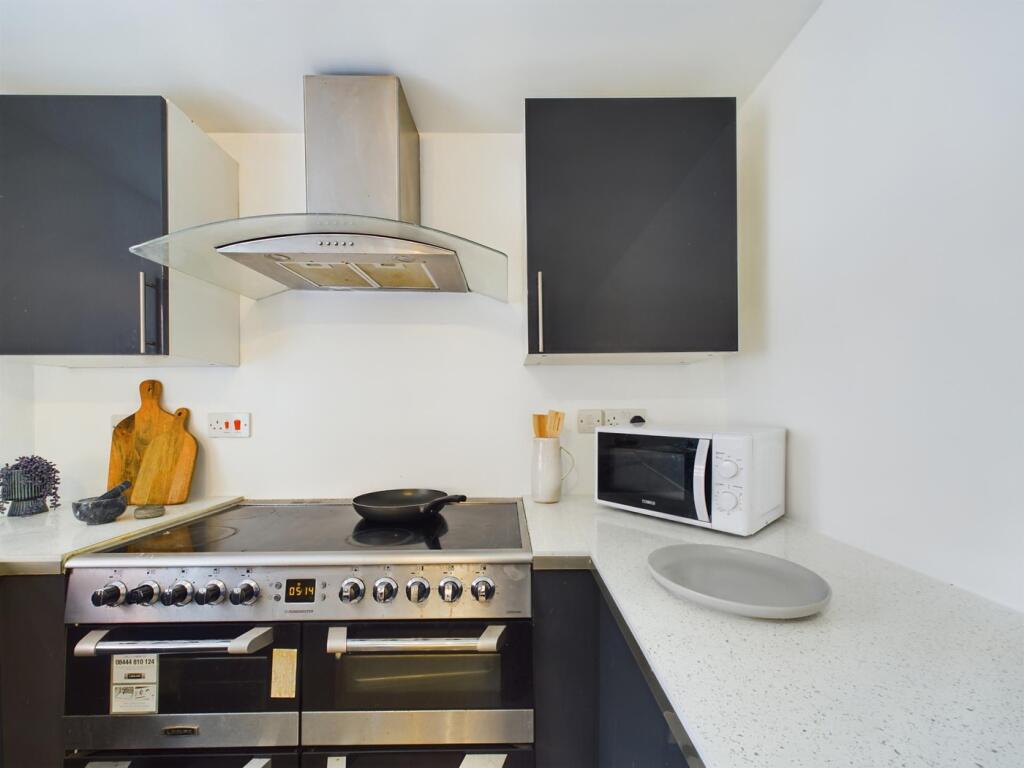 A modern and clean kitchenette featuring stylis...