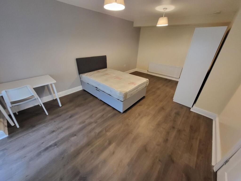 Spacious double bedroom featuring modern floori...