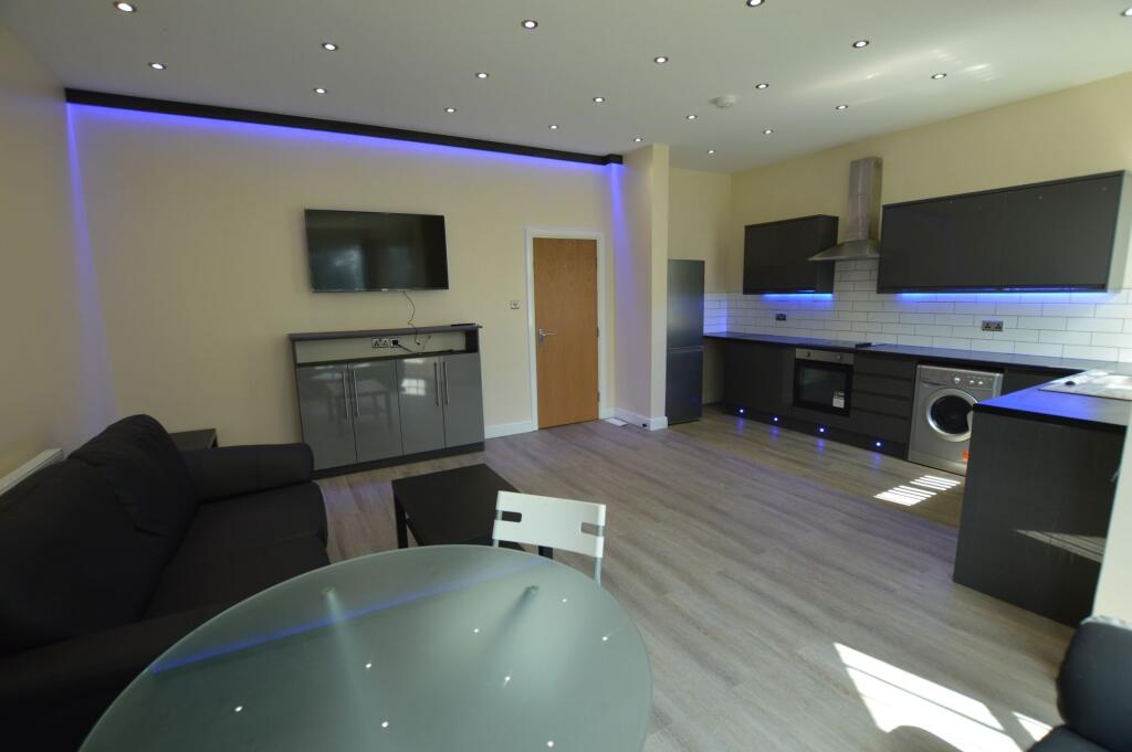 Modern and spacious living room featuring a lar...