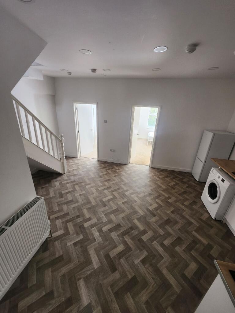 A clean and spacious living area featuring styl...