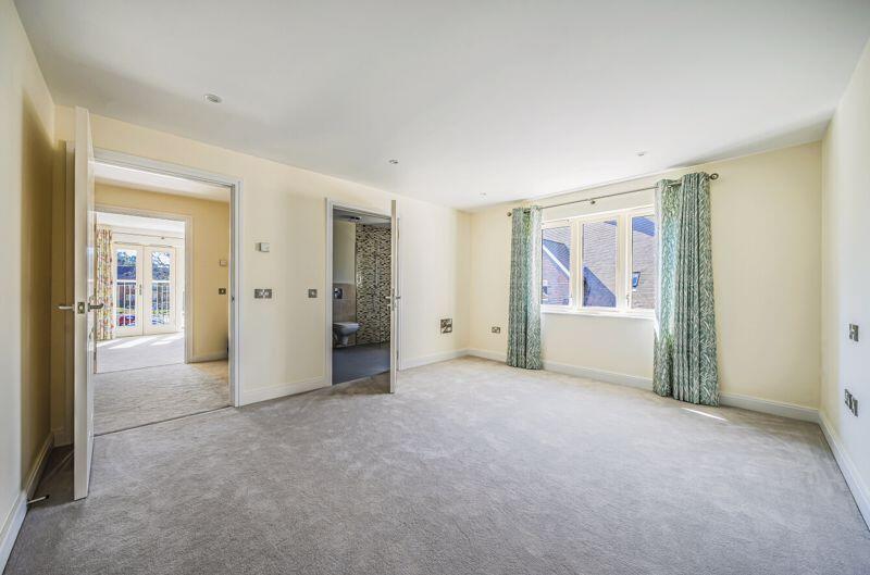 Bedroom with fitted wardrobes and ens...