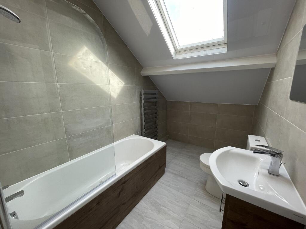 Bright and modern bathroom featuring a large ba...