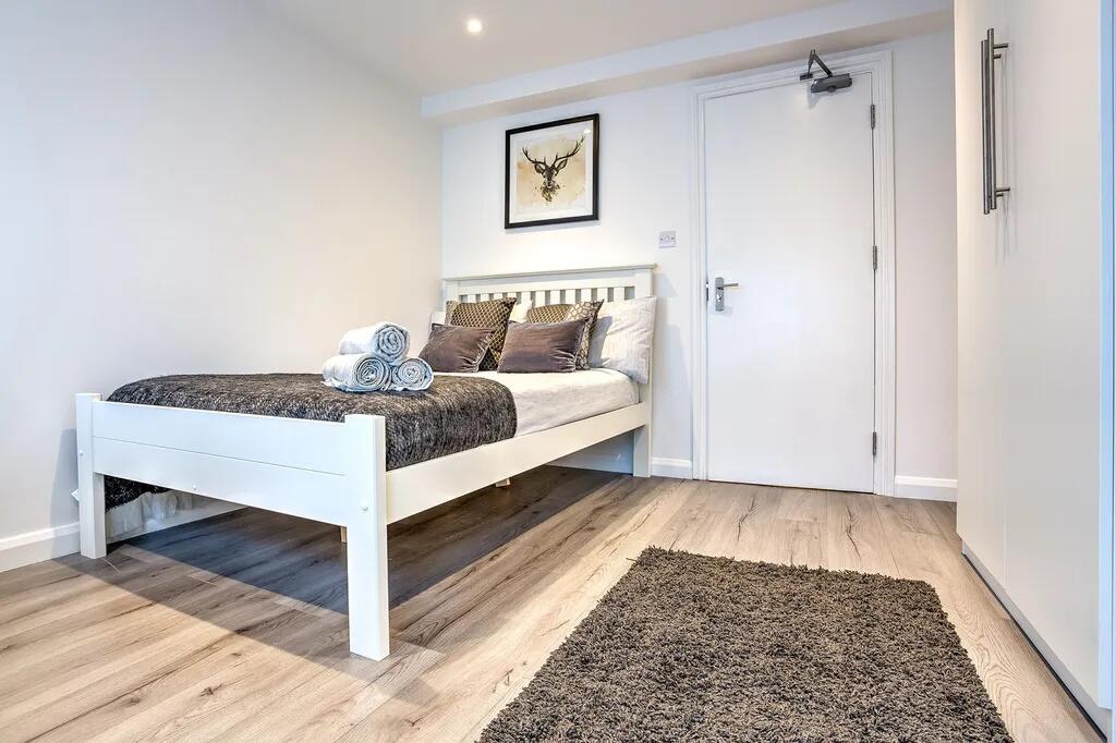 Bright and modern double bedroom featuring a st...