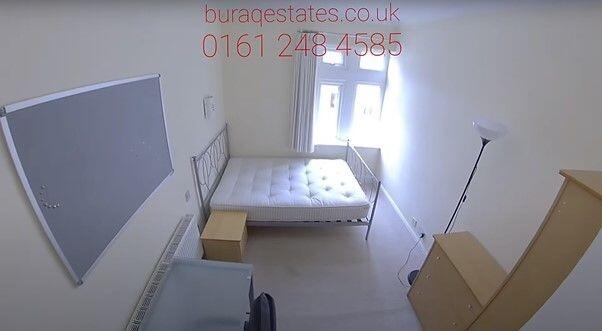 Bright, simply furnished bedroom with a double ...