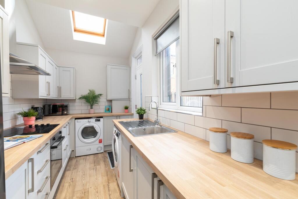 Bright and modern kitchen with ample natural li...