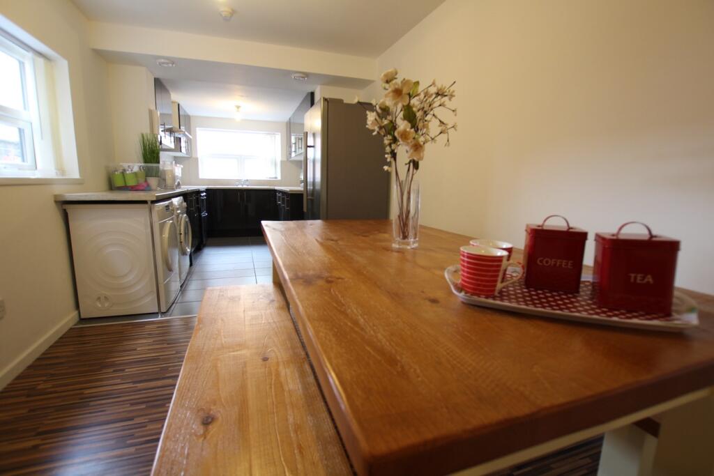 A bright and welcoming living room with ample n...
