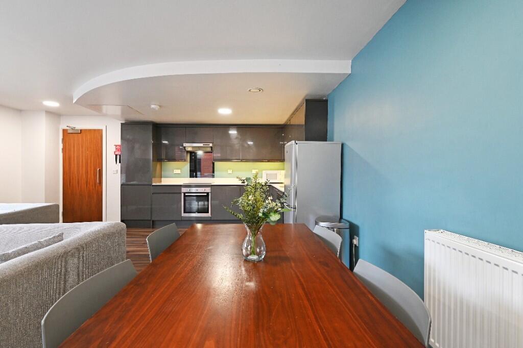 Bright and modern living room featuring an open...