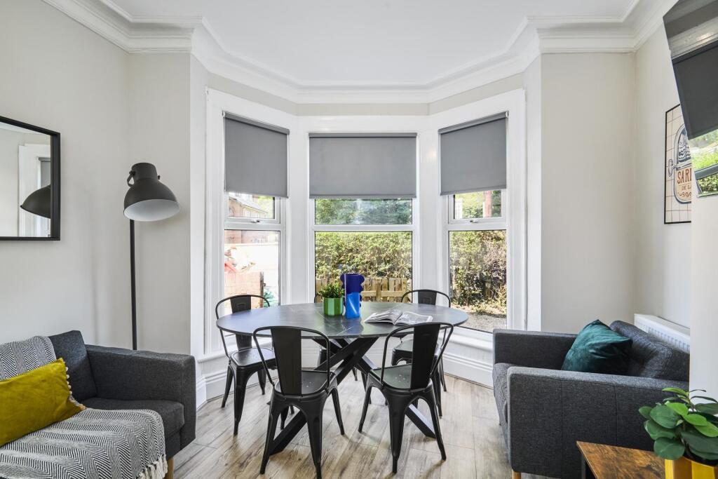Bright and welcoming living room with large bay...