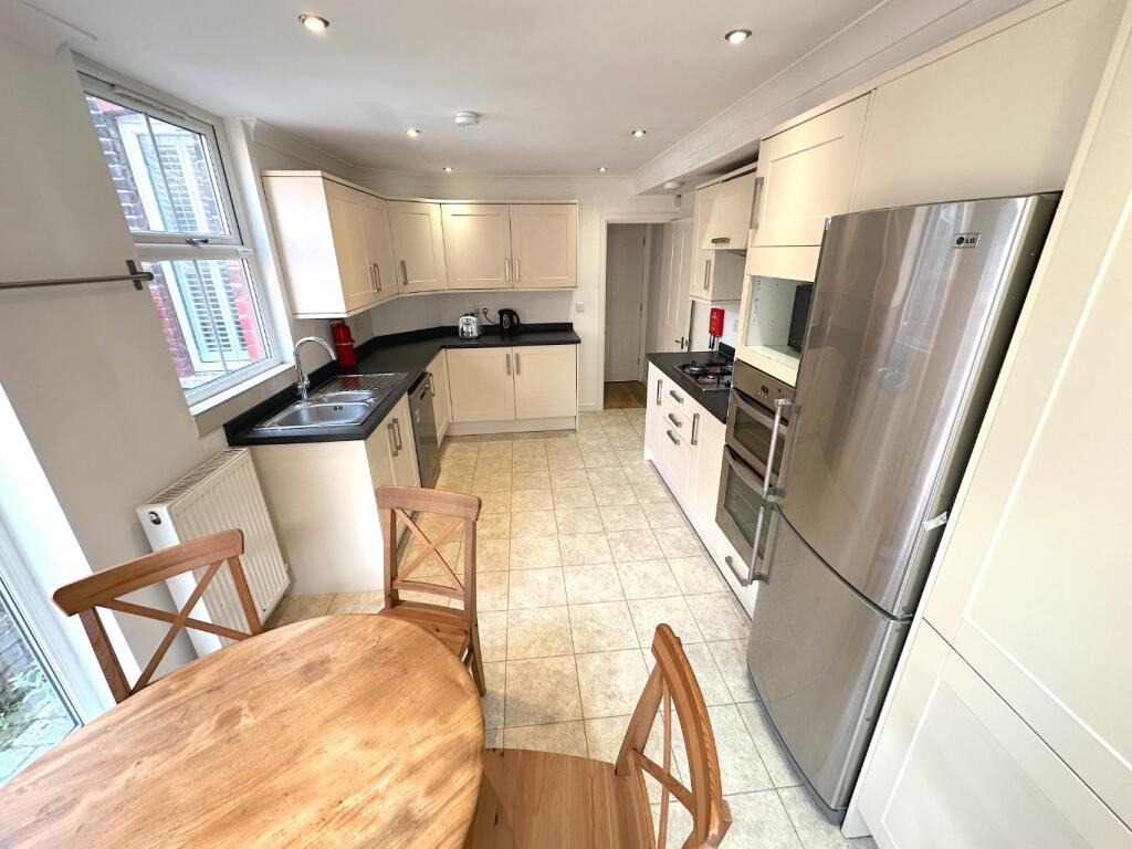 Bright modern kitchen with large fridge, integr...