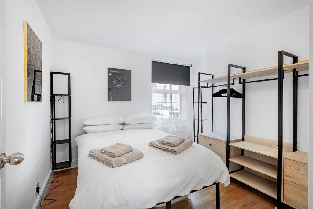 A bright and modern double bedroom featuring a ...