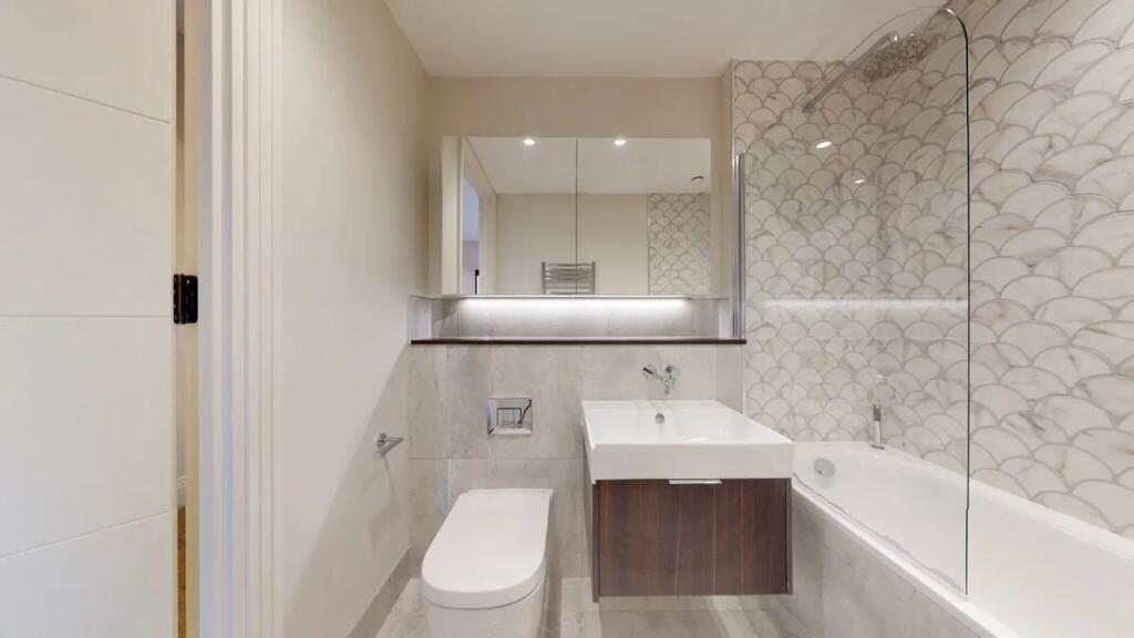 A modern and stylish bathroom suite featuring e...