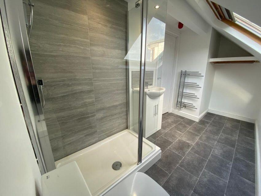 Bright and modern bathroom featuring a spacious...