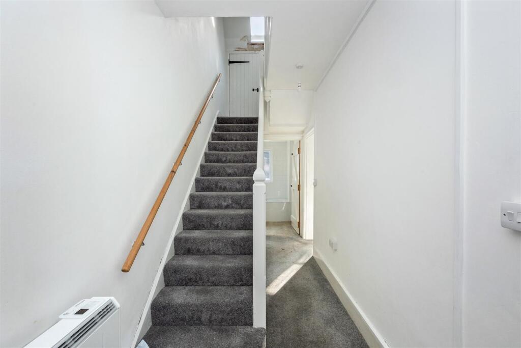 Stairs rising to First Floor
