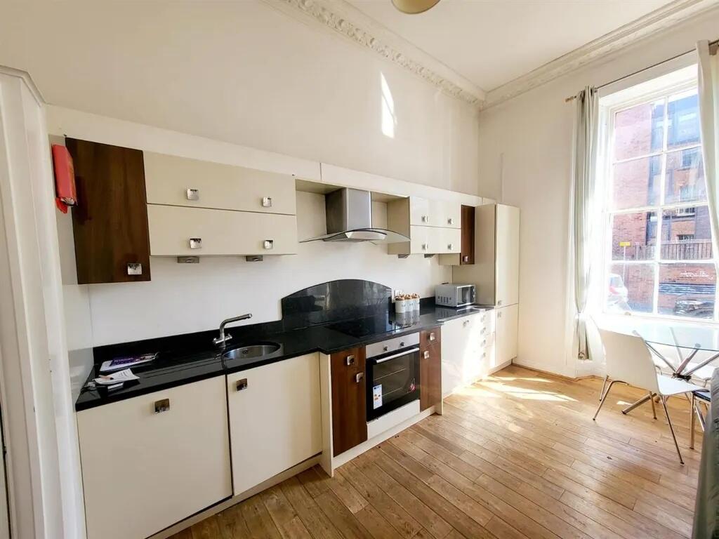 Bright and modern kitchen space featuring sleek...