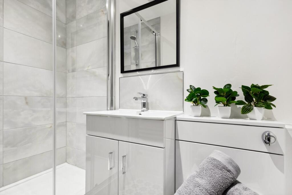 This modern bathroom features sleek fixtures an...