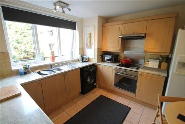 Bright and modern kitchen featuring ample natur...