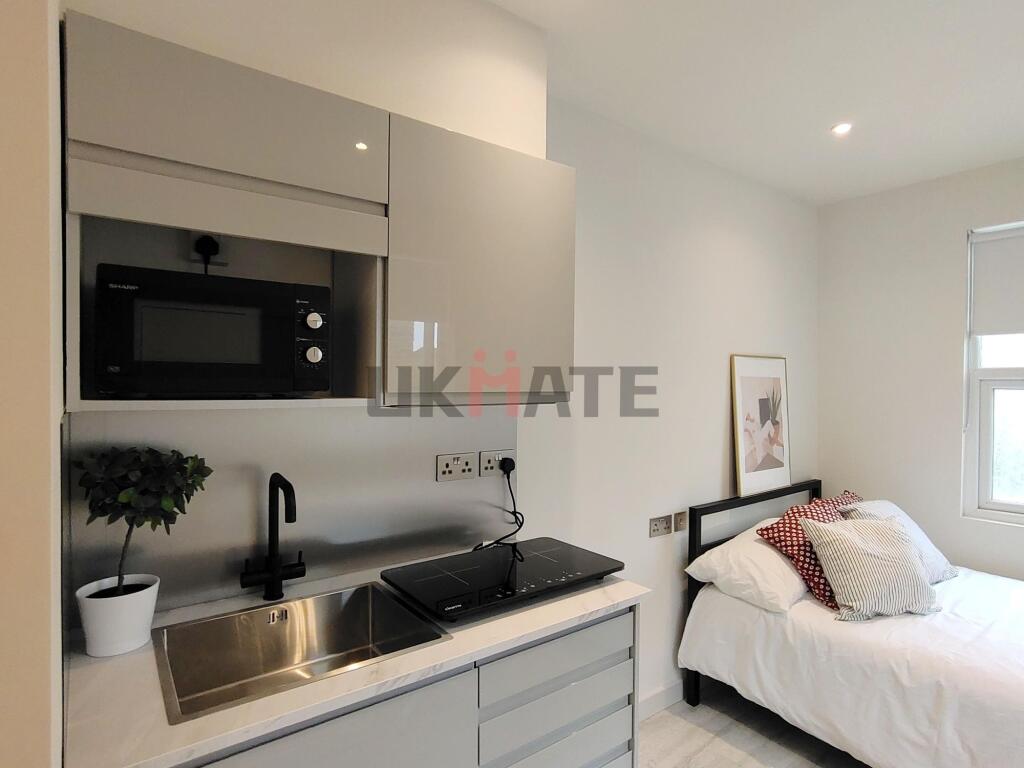 A modern, well-maintained studio with a compact...