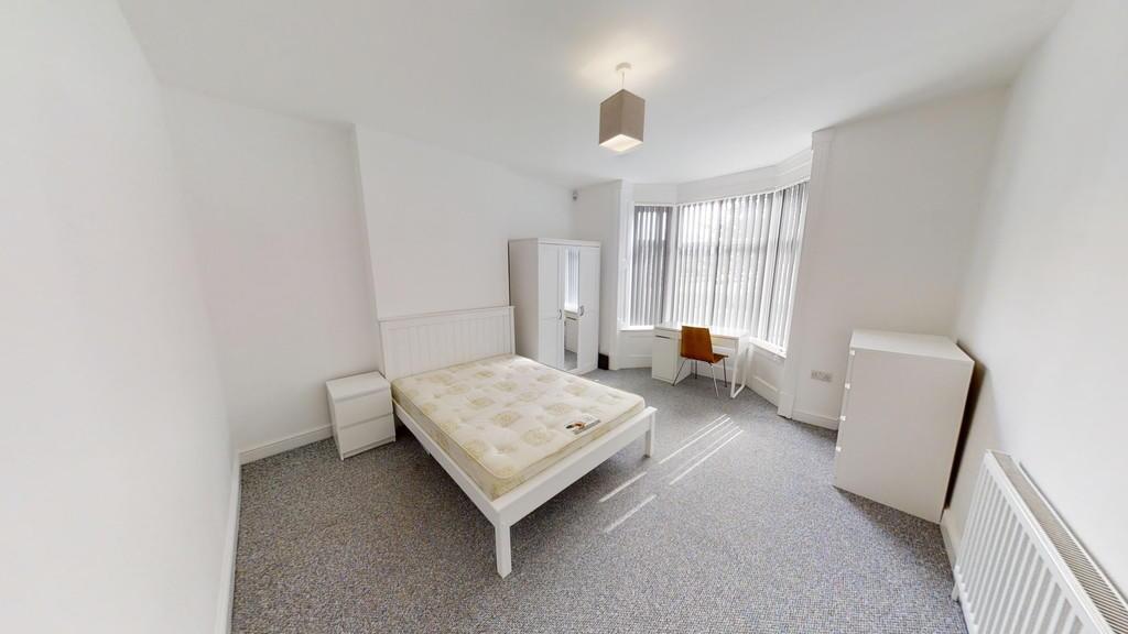 Bright and airy double bedroom featuring a larg...