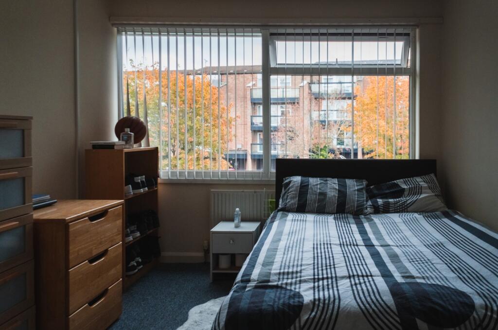 A bright and inviting double bedroom with large...