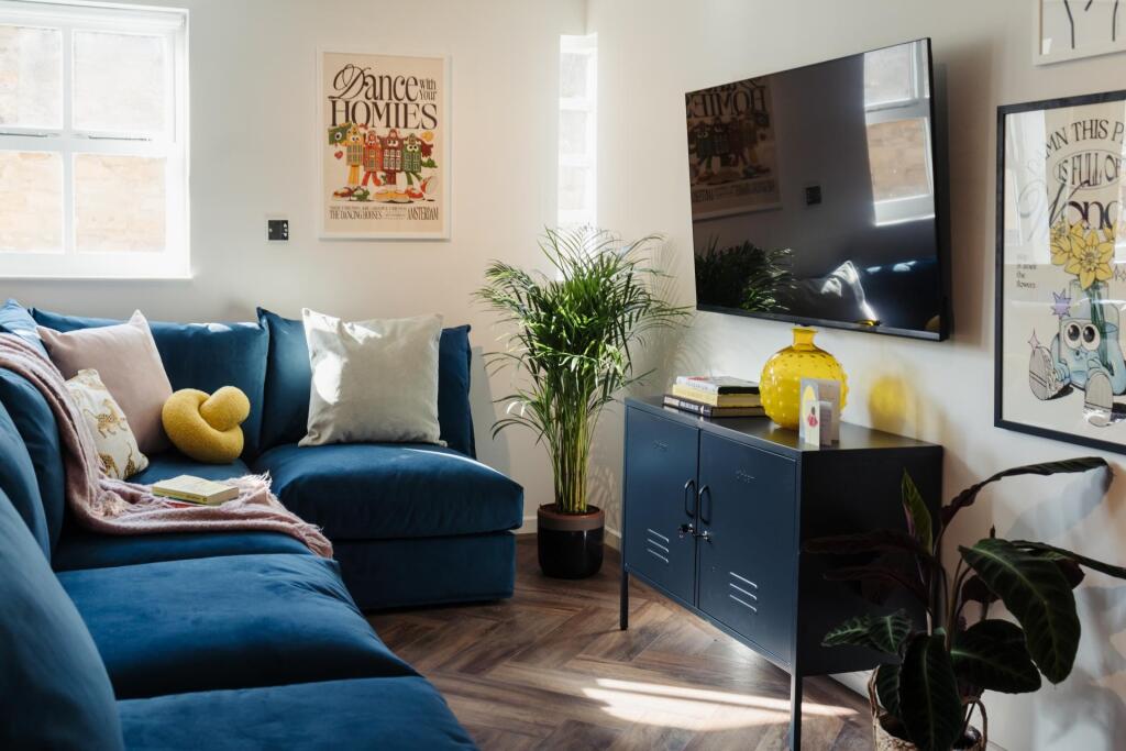 A welcoming and stylish living room featuring a...
