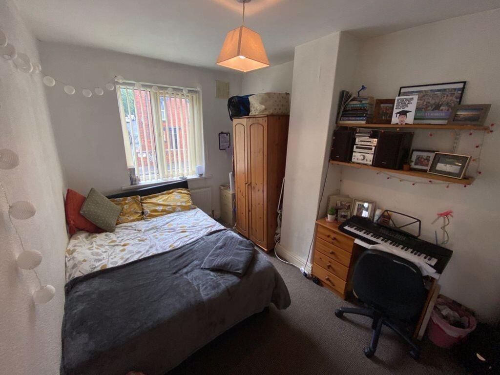 A cozy double bedroom featuring a comfortable d...