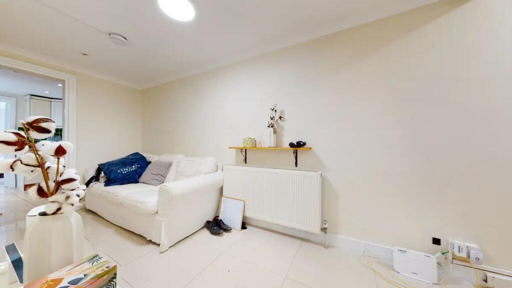 A cozy living room featuring a white sofa again...