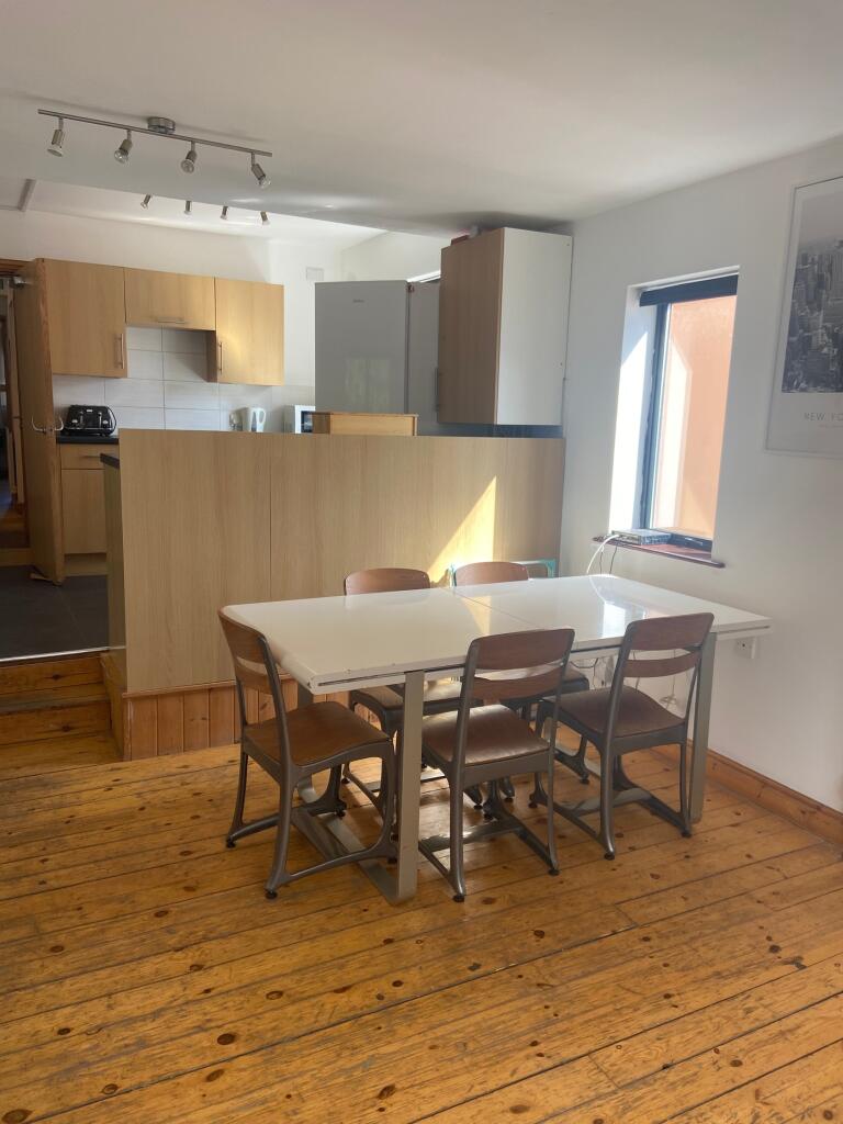 A bright and tidy kitchenette with a dining are...