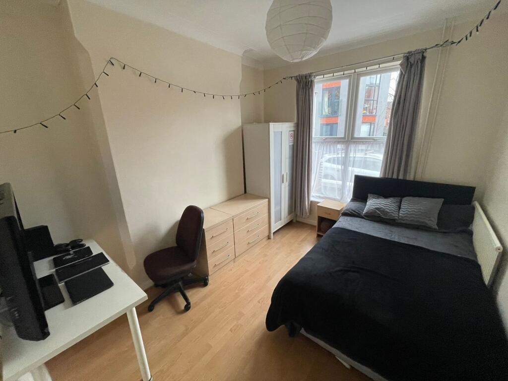 A bright and welcoming double bedroom featuring...