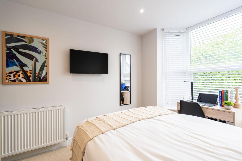 Bright and modern bedroom with a large window a...