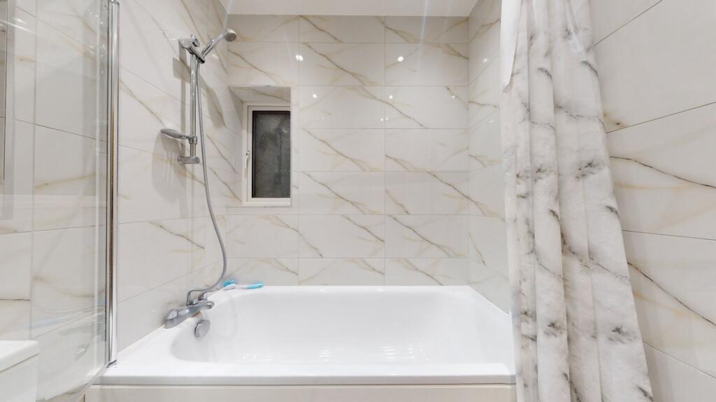 A modern bathroom suite featuring a clean white...