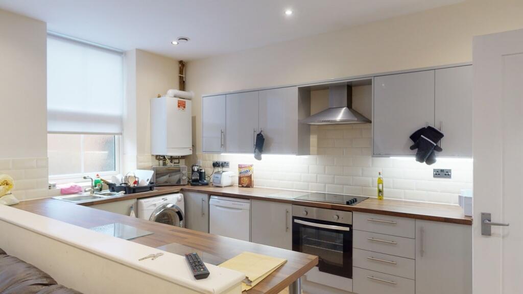 Bright and modern kitchen featuring sleek cabin...