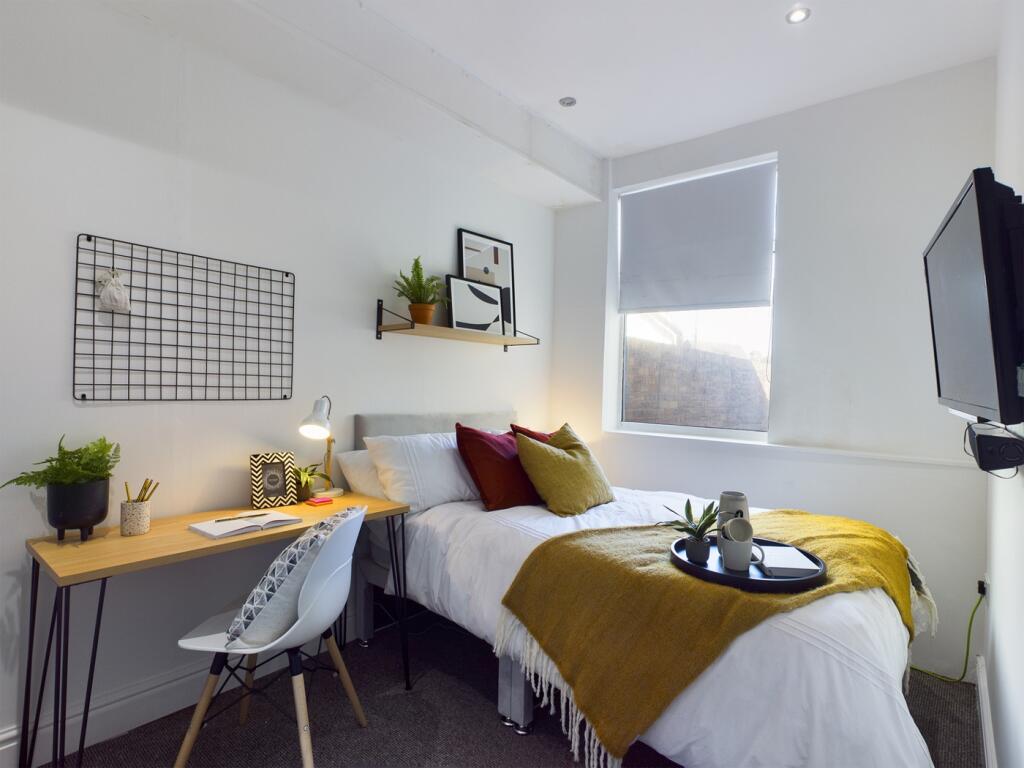 A bright and cozy double bedroom featuring styl...