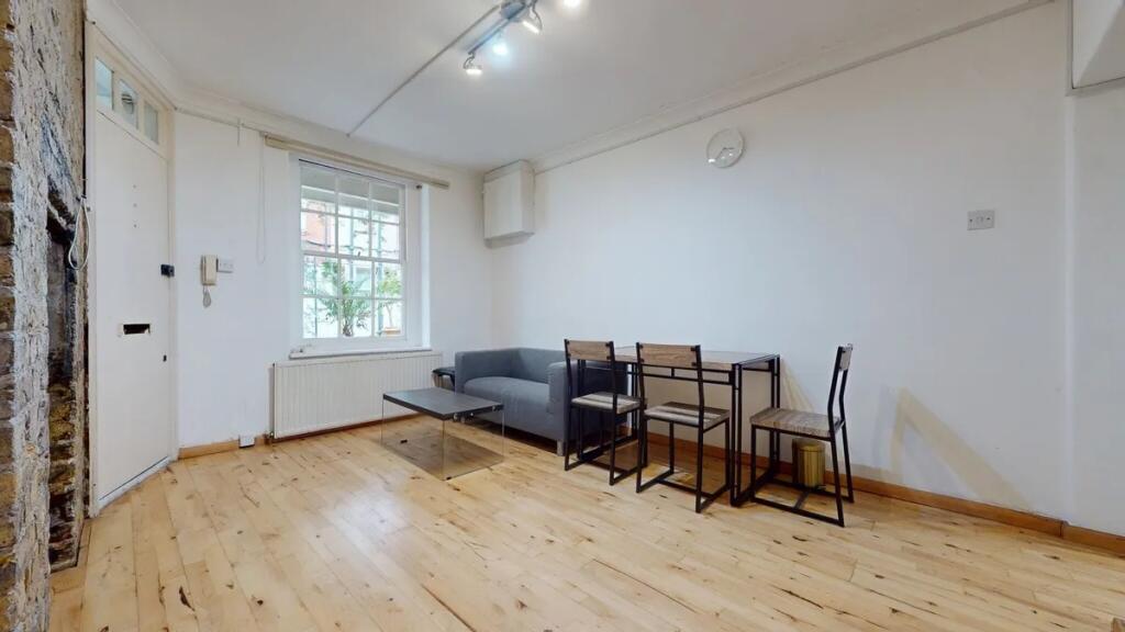 A bright and tidy living room featuring a large...