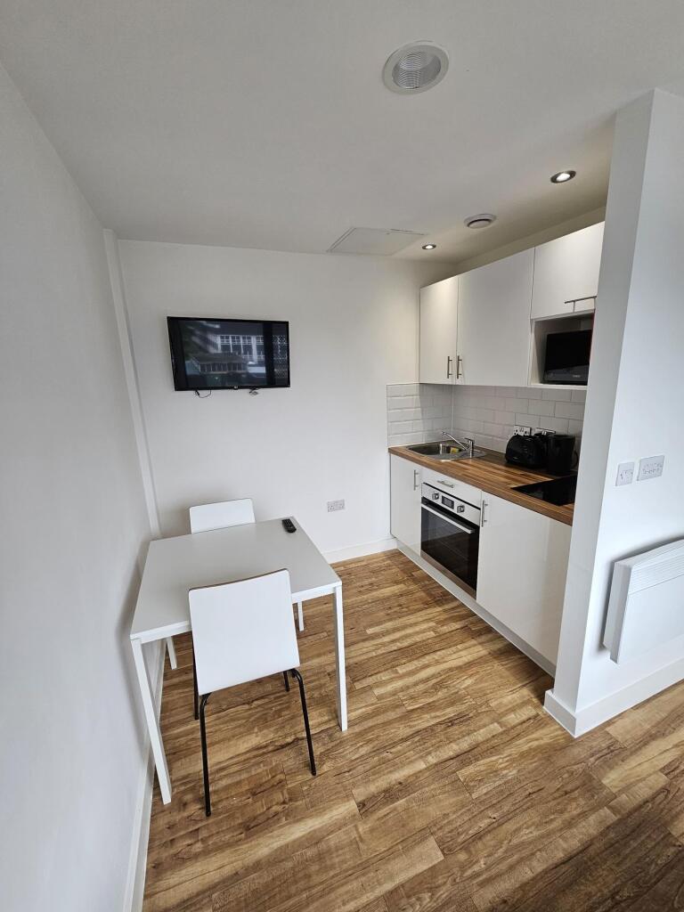 A modern and tidy kitchenette featuring a built...