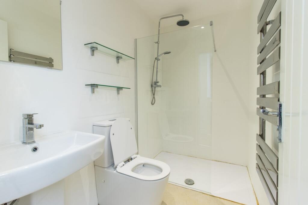 Modern and minimalistic bathroom featuring a wh...