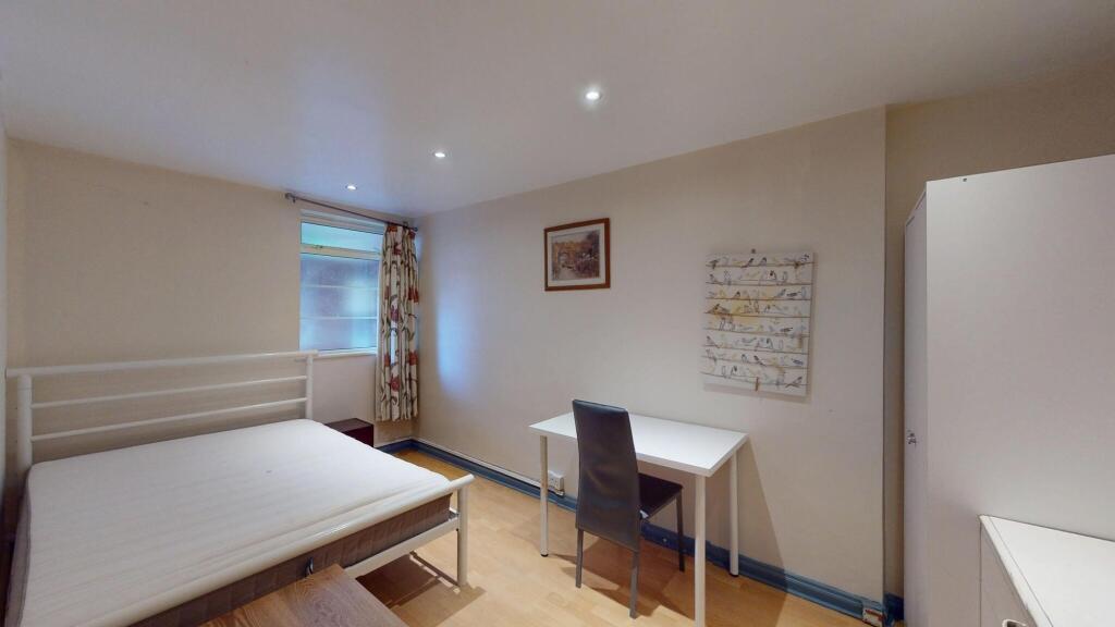 A bright and tidy double bedroom featuring a co...