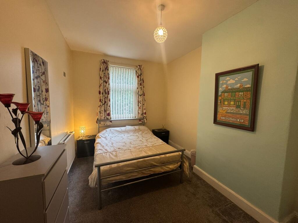 A cozy double bedroom featuring a double bed an...