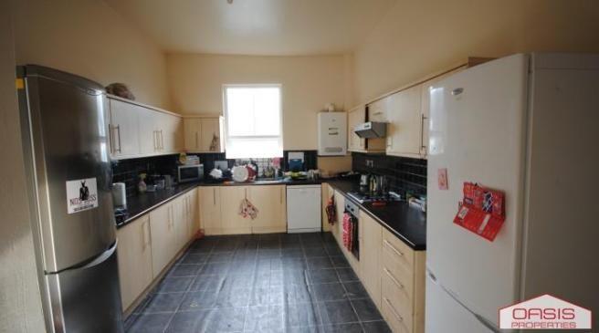 A well-maintained kitchen with ample natural li...
