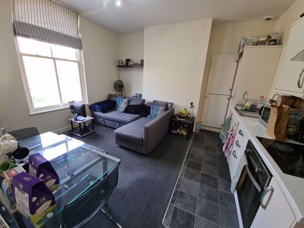 A bright and welcoming living room featuring mo...