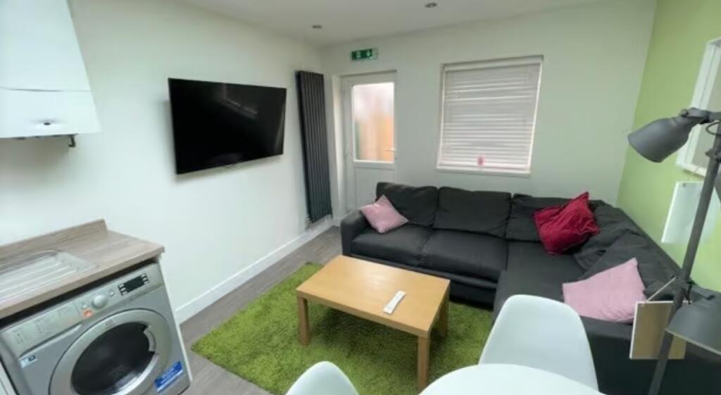 Bright and modern living room featuring a comfo...