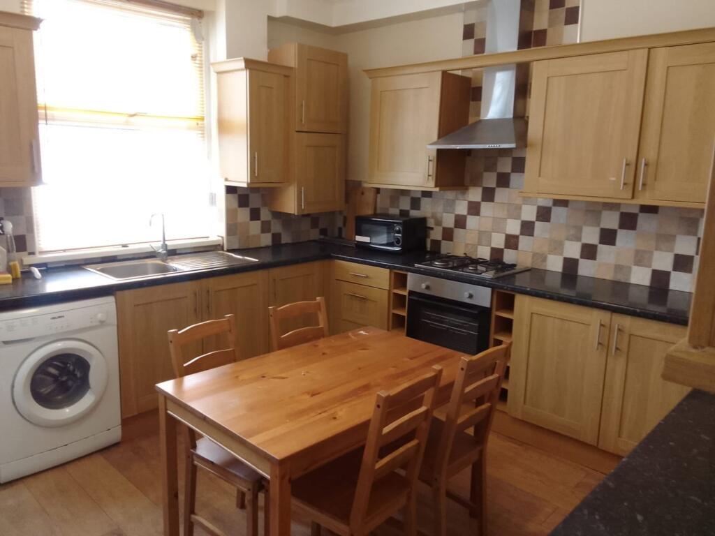 A bright and practical kitchen featuring wooden...
