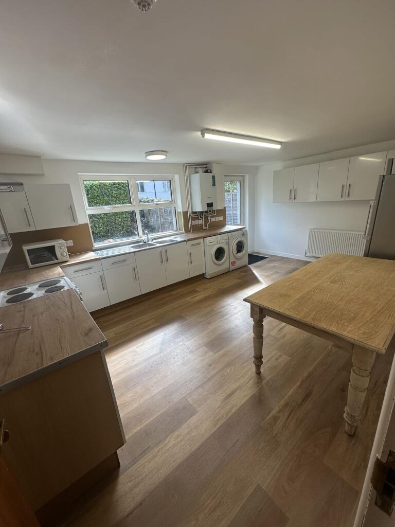 Bright and modern kitchen with large windows pr...