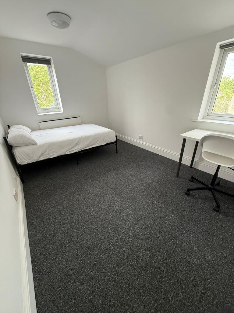 Bright and inviting double bedroom featuring la...