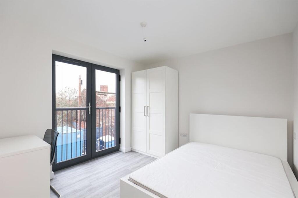 A bright and spacious double bedroom featuring ...