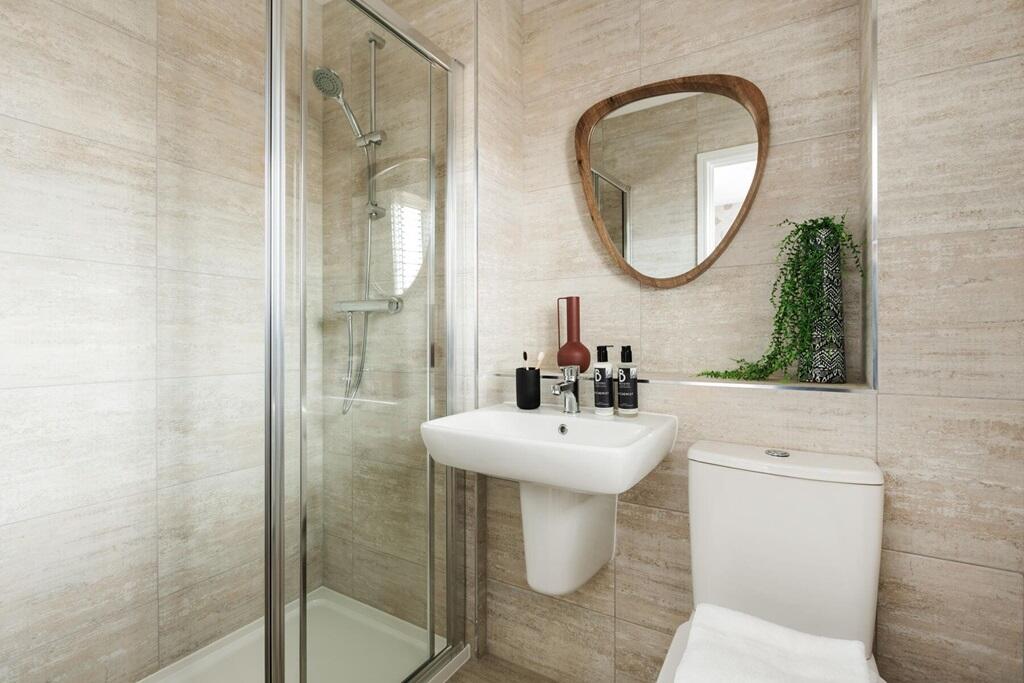 The main bedroom boasts an en-suite shower room
